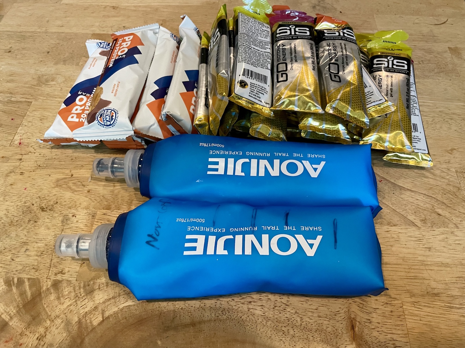 A large collection of energy bars, gels, and drink mix as the athlete prepares for an epic ride.