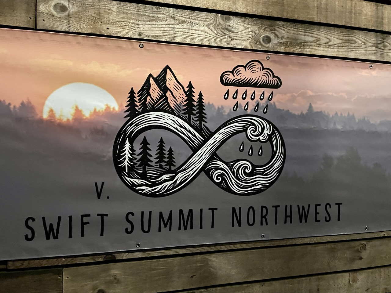 A large vinyl banner for the Swift summit featuring an artistic infinity symbol for an 8.